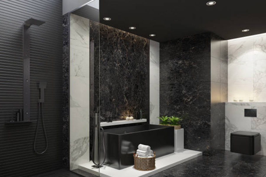 Black hanging toilet in all-black marble bathroom with shower