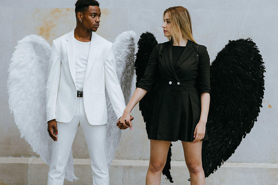 Couple in contrasting angel costumes