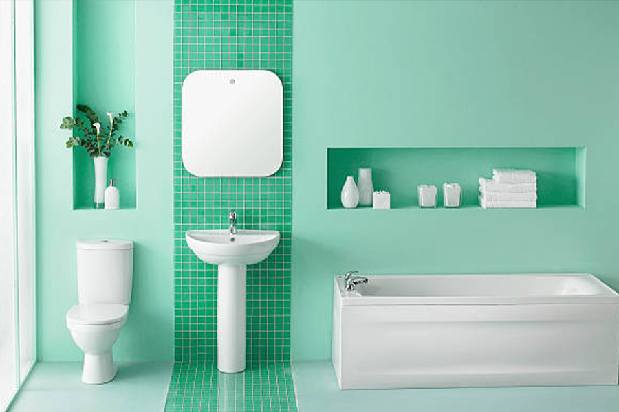 Green bathroom with matching toilet and basin in white