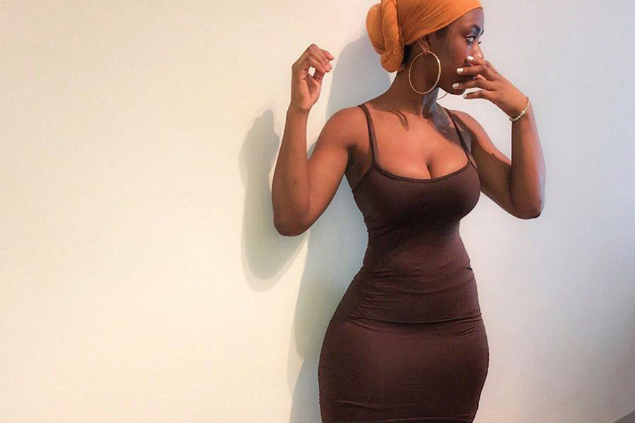 Hour-glass shape lady wearing a brown bodycon dress