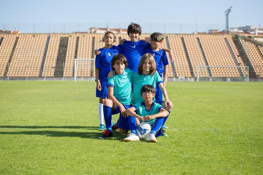 Kids wearing jerseys in a soccer field