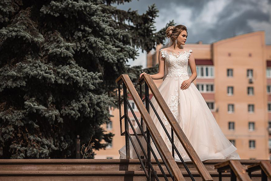 Lady rocking a wedding ball gown on a staircase