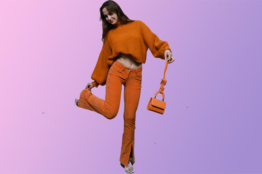 Lady rocking an orange crop top and flared pants