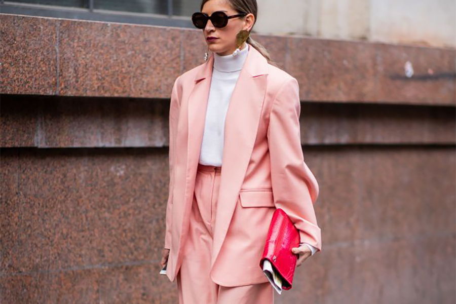 Lady wearing pink blazers with pants and white turtle-neck