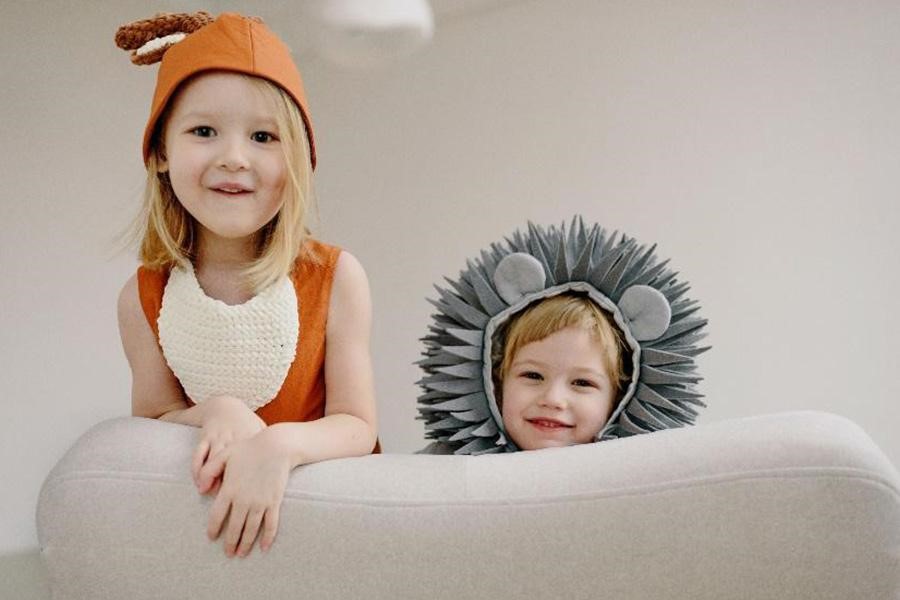 Little girl and boy wearing animal costumes