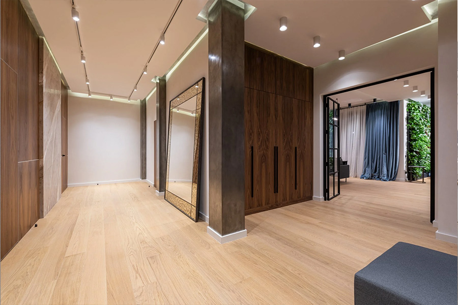 Modern apartment hallway with wooden parquet and walls