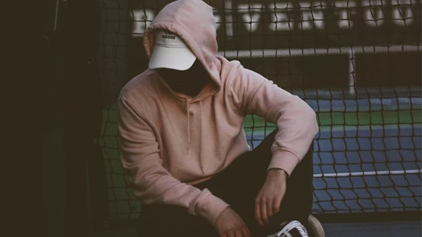 Person Pairing A White Cap With A Pink Hoodie And Black Joggers
