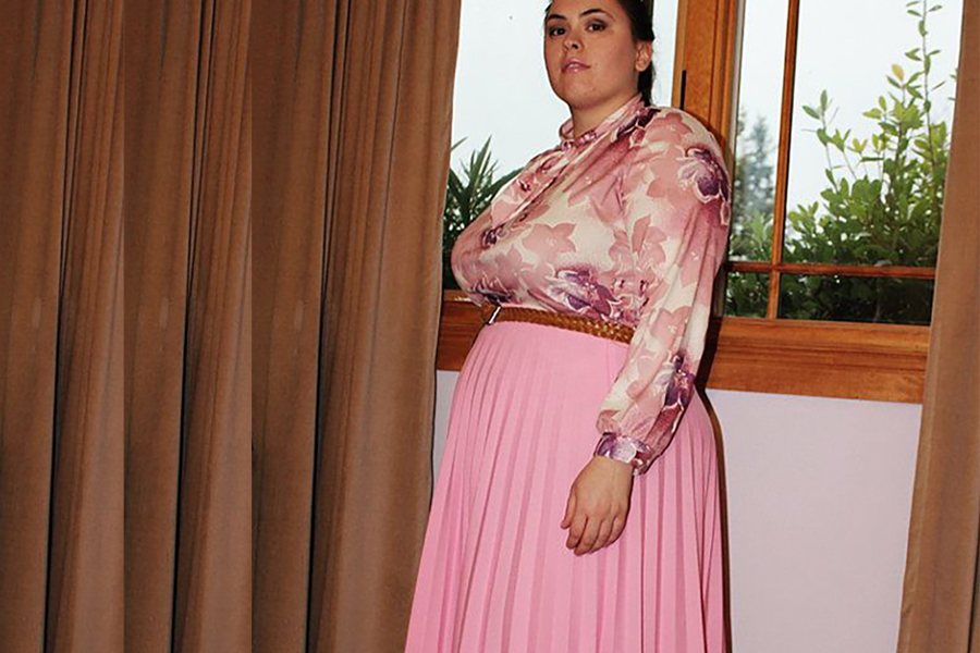 Plus-size woman wearing a pink dress with sweetheart neckline
