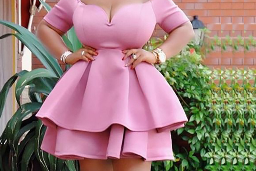 Plus-size woman wearing a pink dress 