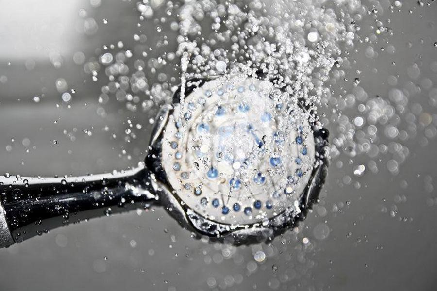Round shower head spraying water
