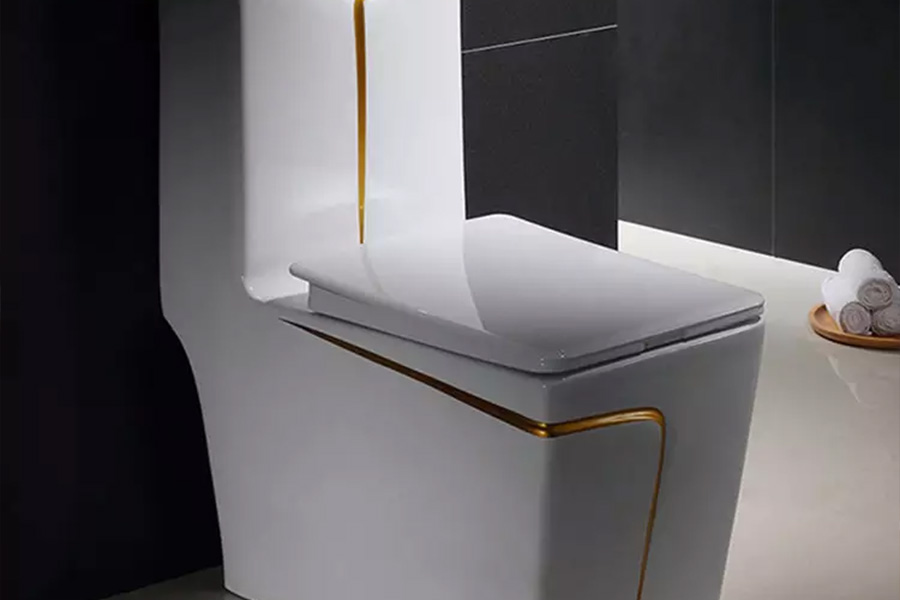 White modern toilet with lines of gold through the body