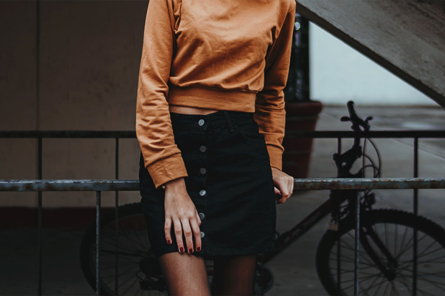 Woman wearing black button-front mini pencil skirt