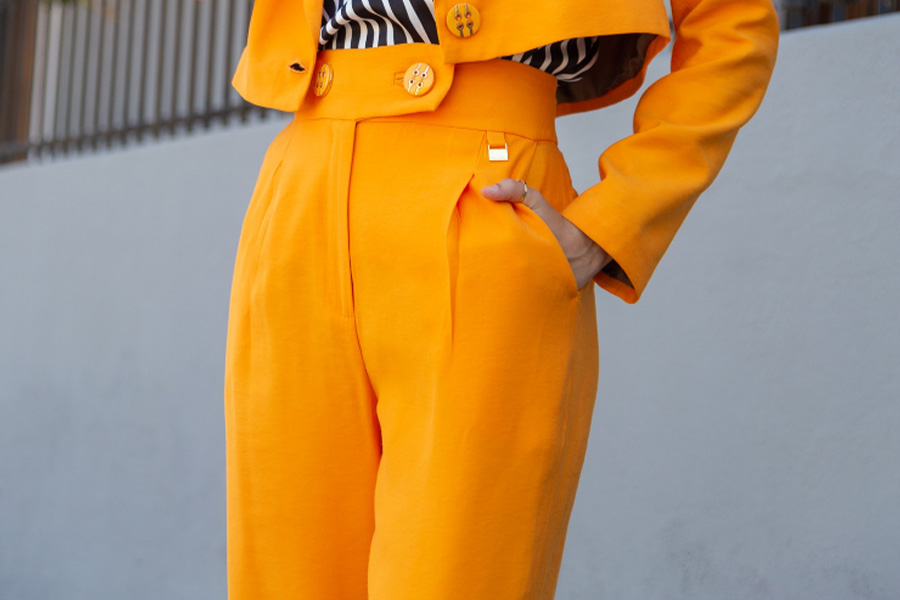 Woman wearing orange high waisted barrel-leg pant