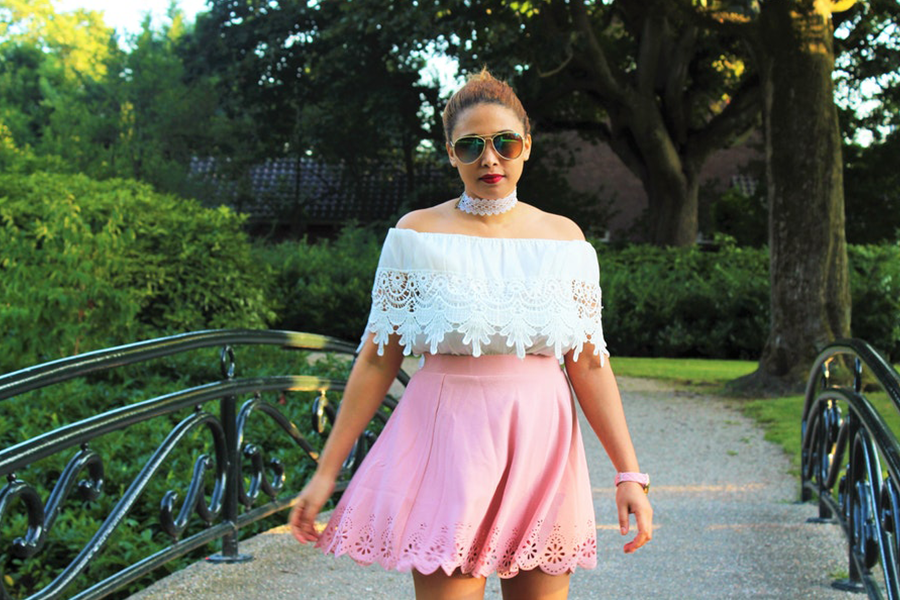 Woman wearing pink flare skirt with an off-shoulder top