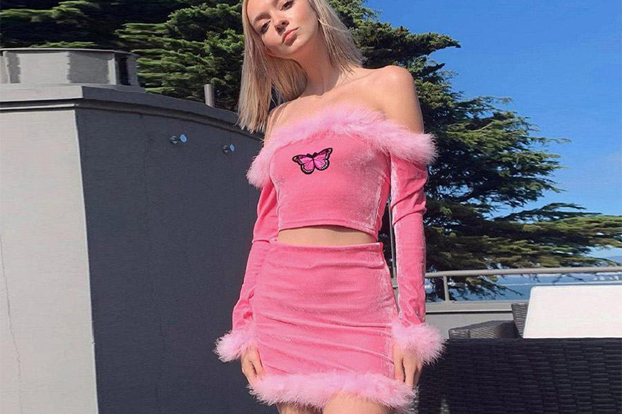 Woman wearing a pink Y2K set with fur detailing