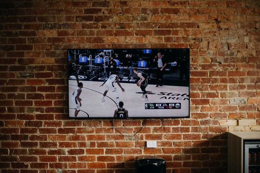 A floating TV stand on exposed brick