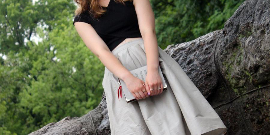 A lady wearing a long gray proper skirt
