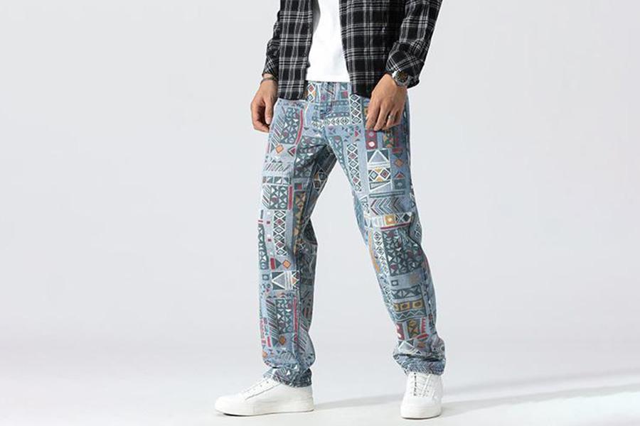 A man in denim trousers with digital print