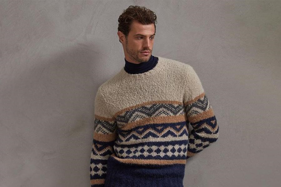 A man wearing a patterned sweater
