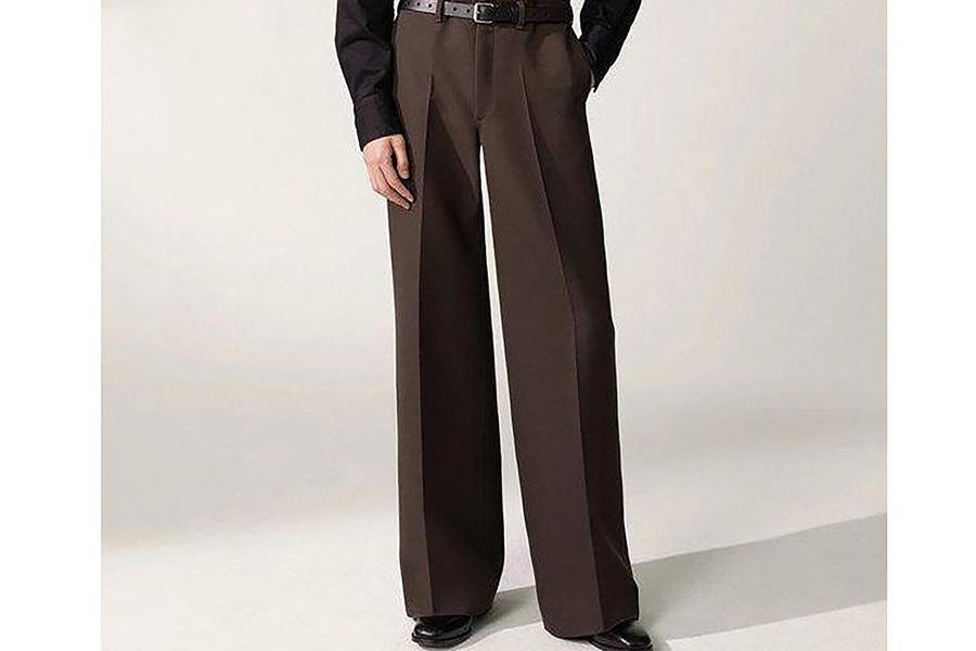A man wearing long brown wide-leg trousers
