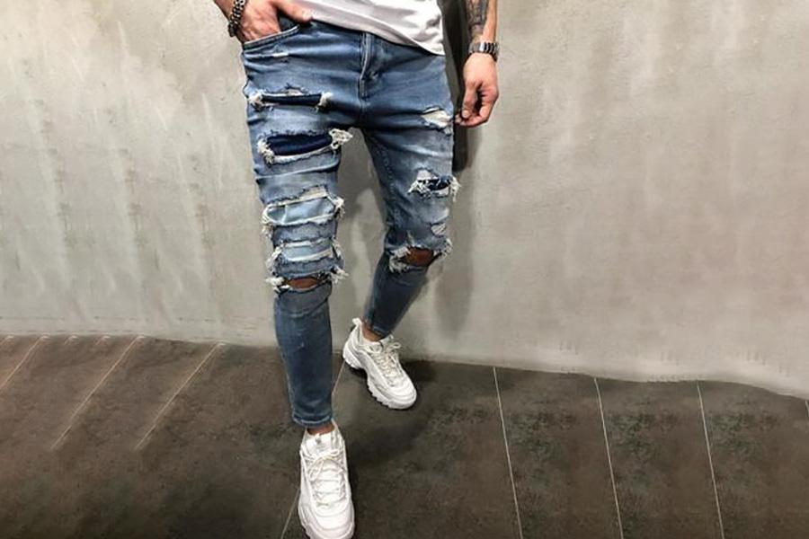 A man wearing ripped jeans