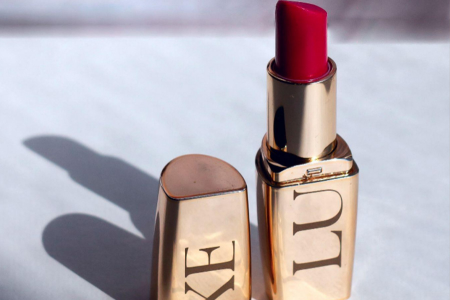 A red Luxe lipstick in a golden tube