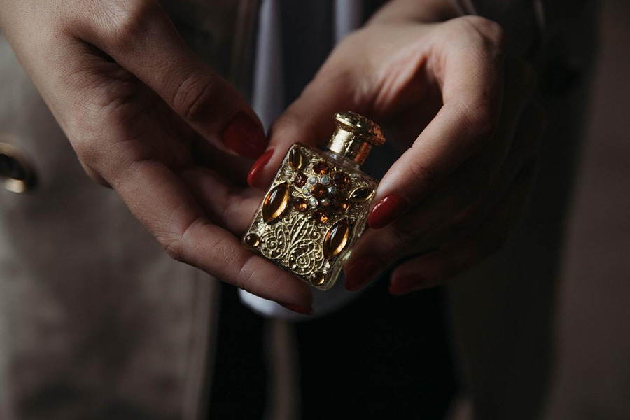A woman holding a stone embedded perfume