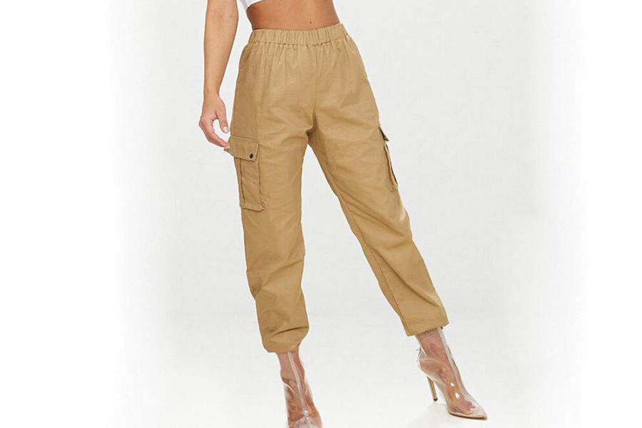 A woman in cream cargo pants and transparent heels