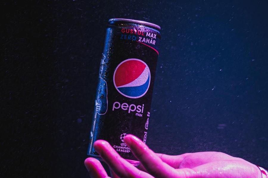 Anonymous hand holding a can of Pepsi