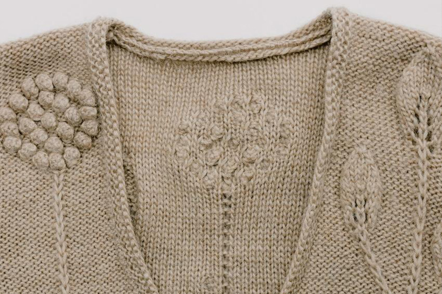 Beige knitwear with floral embroidery