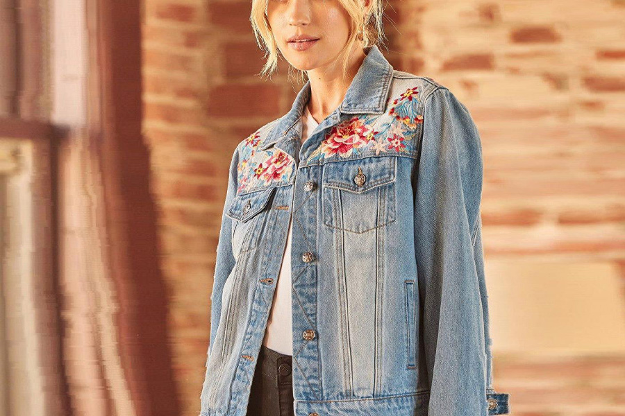 Blonde wearing a denim jacket with flower embroidery