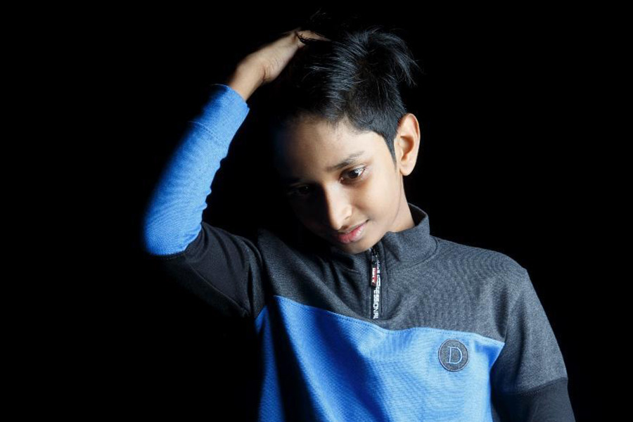 Boy in a blue and black half placket top