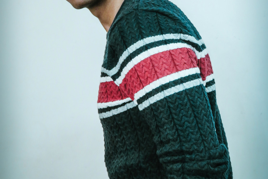 Green knit sweater with red and white stripes