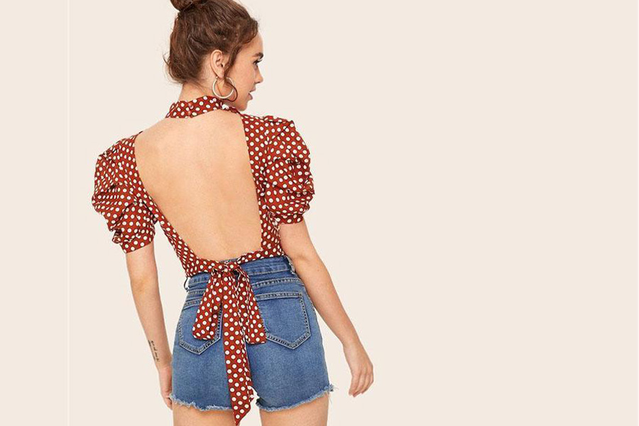 Lady in a red polka-dot puff sleeve open back top