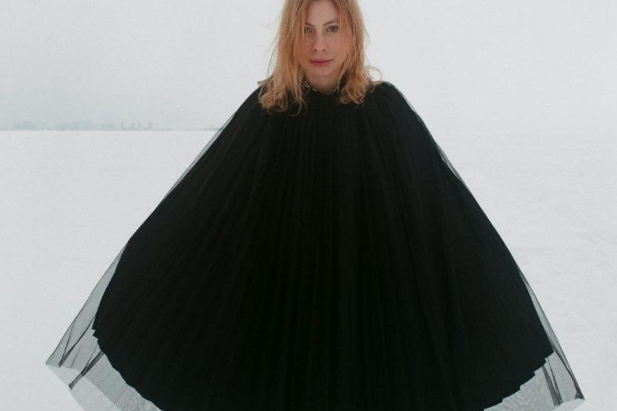 Lady wearing a black silk-layered poncho