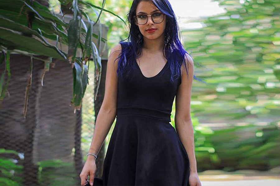 Lady wearing a dark blue short flare dress outdoors 