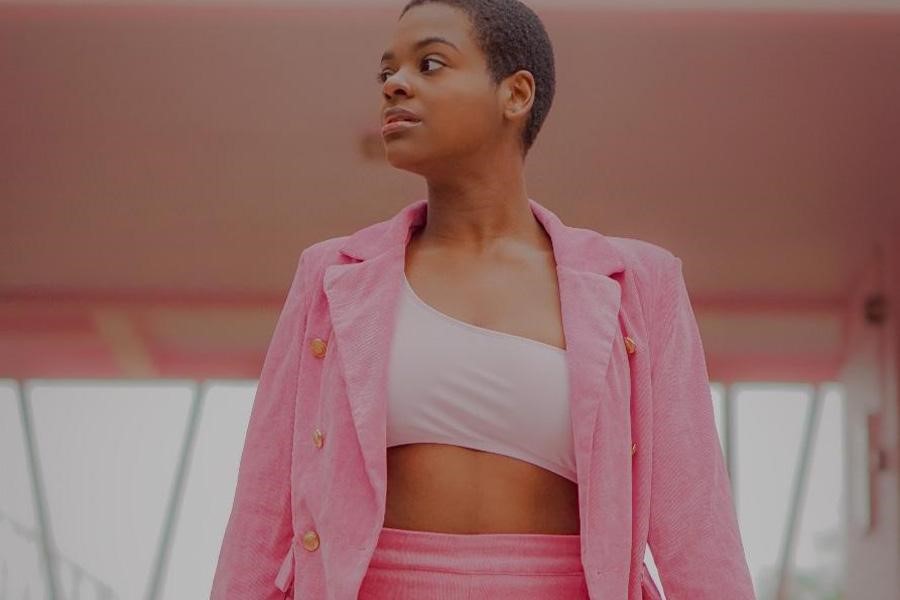 Lady wearing a pink guava blazer and pants