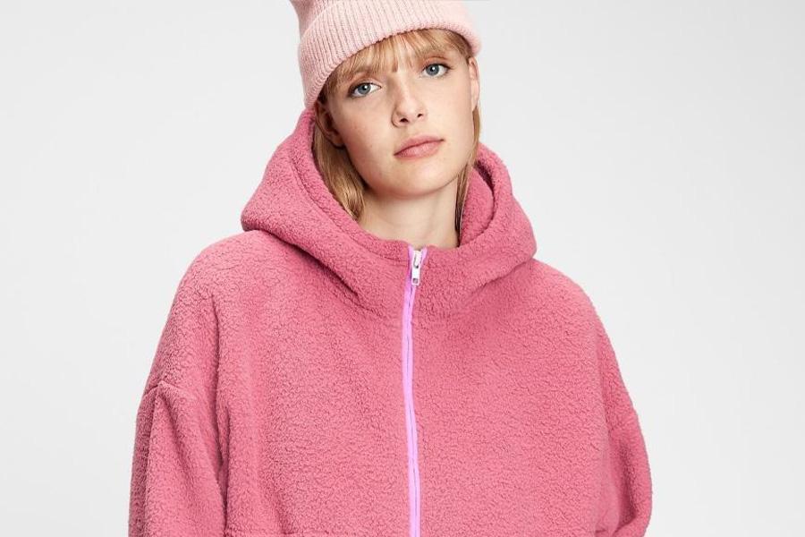Lady wearing a pink half-zip hoodie