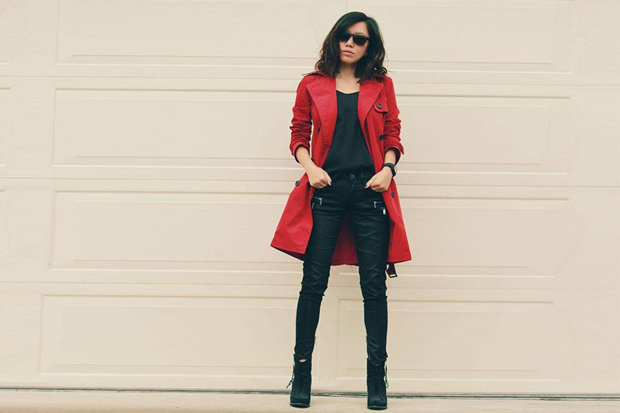 Lady wearing a red trench coat over black jeans