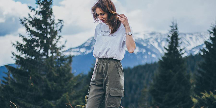 Lady wearing a white top over army green cargo pants