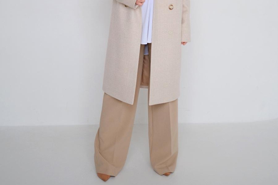 Lady wearing cream-colored wide-leg trousers