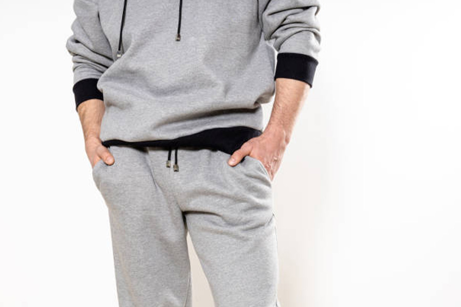 Man in gray cargo sweatpants and a gray hoodie