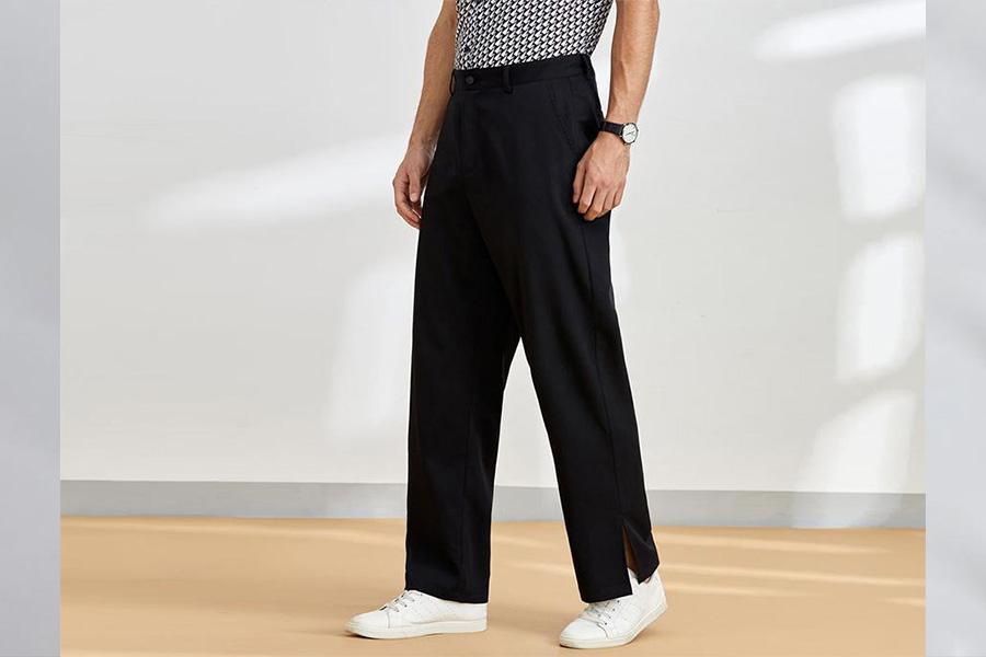 Man rocking design-print top and black split-hem pants