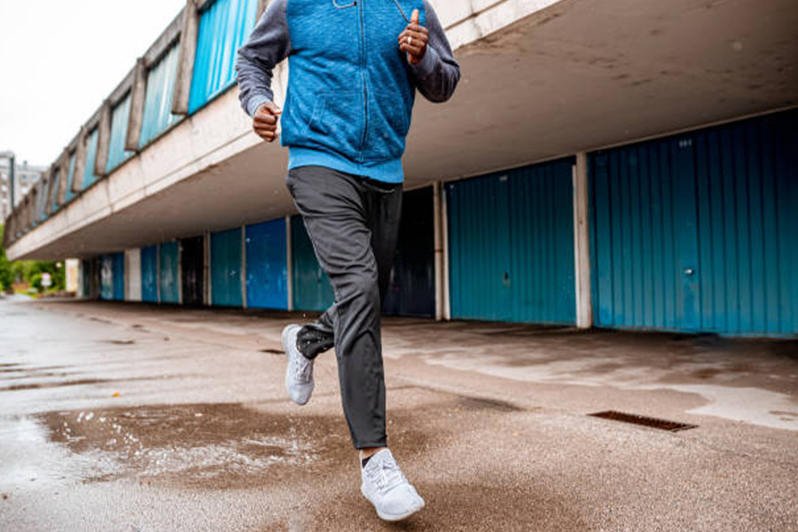 Man running wearing gray slim-fit jogging pants