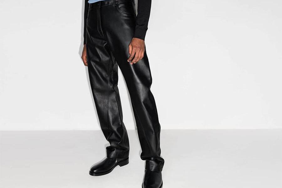 Man wearing a long-sleeve over a black wide-leg leather pants