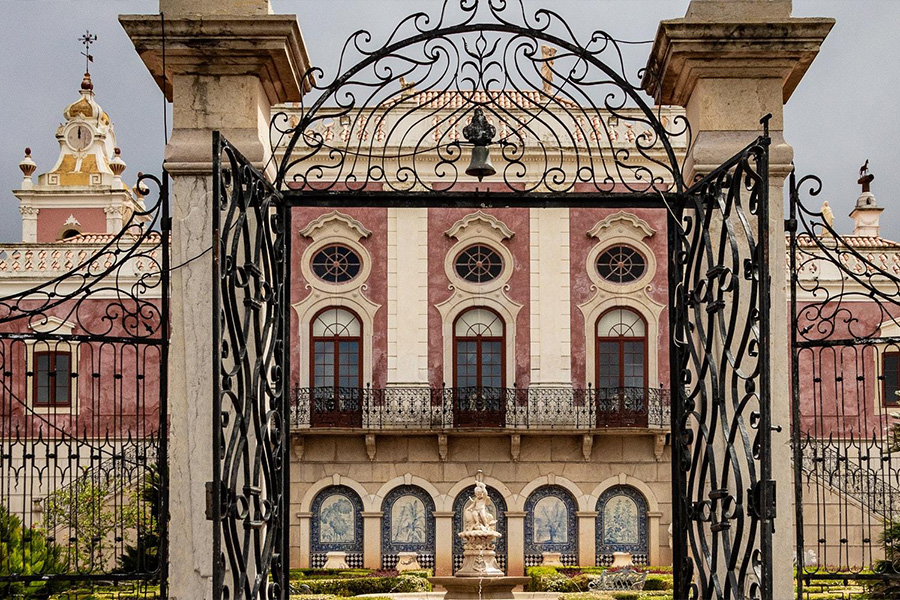 Open swing gate in front of large building