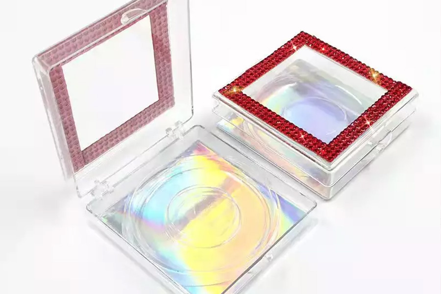 Small plastic boxes for eyelashes with glitter around edges