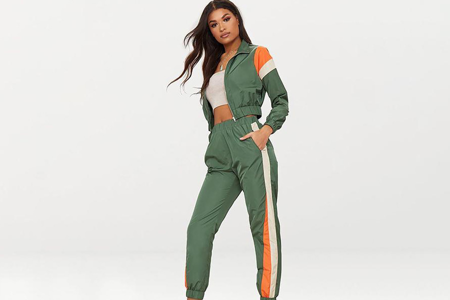 A woman in a green and orange tracksuit