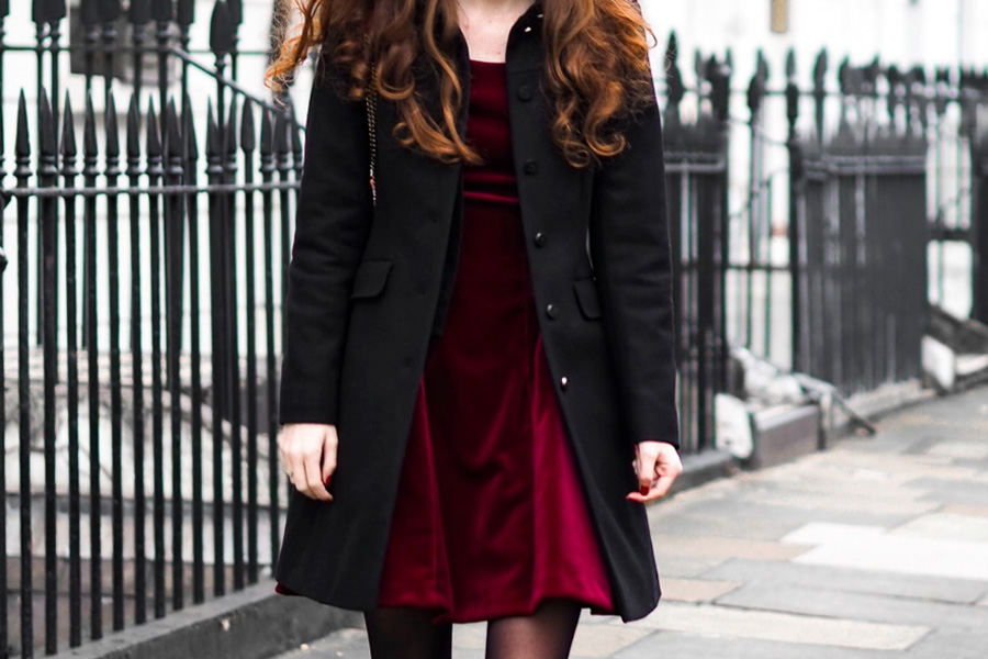 Woman in black tailored top coat
