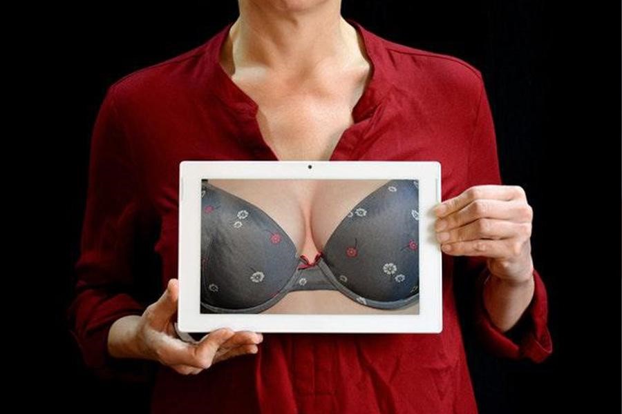 Woman showing a picture of breasts in a tablet